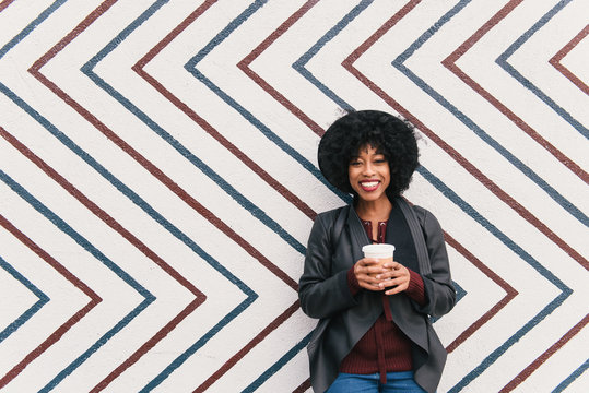 Portrait of woman in front of zig zag pattern wall