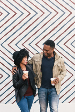 Couple in front of zig zag pattern wall