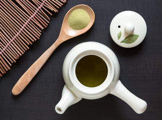 Obraz na płótnie Canvas Top view of green matcha tea set on brown table and bamboo. Asian culture