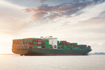 Container Cargo freight ship with working crane bridge in shipyard at dusk for Logistic Import...