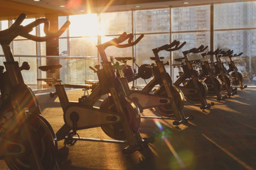 Naklejka na ściany i meble Modern gym interior with equipment, fitness exercise bikes