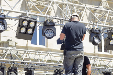 lighting technician installing professional  lighting equipment