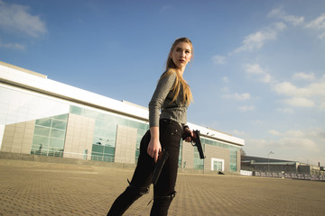 Powerful Woman Holding Gun Action Movie Style - Portrait of a girl in a heroine cosplay...