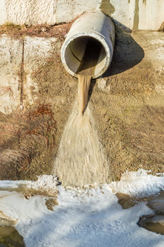 Concrete circular pipe discharging water to a canal