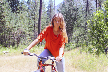 Fototapeta na wymiar Portrait of a young girl with a bicycle