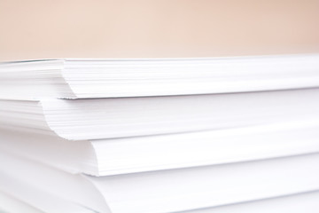 Stack of white paper. Blurring background. The corners of sheets of paper close-up.