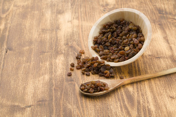 Raisins on a wooden spoon