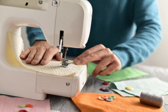 young man using a sewing machine