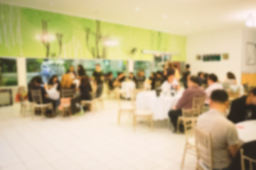 Blurred people in conference room or restaurant.