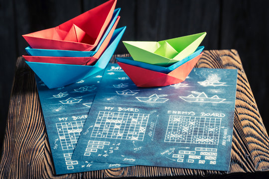 Children's battleship paper game with red and blue ships