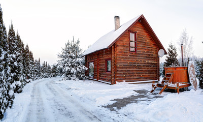 Traditional wooden house in the snow. Winter in Europe. Lithuania.