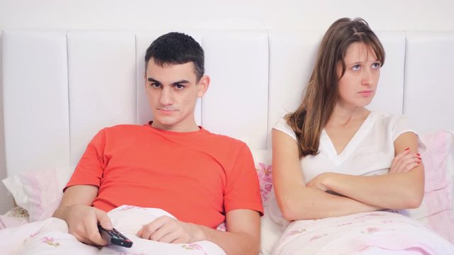 Young couple quarrel because of tv