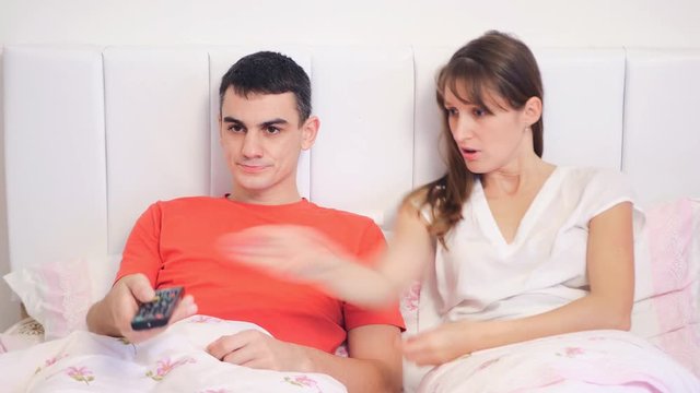 Young couple quarrel because of tv