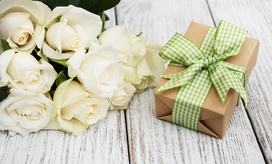 White roses and gift box