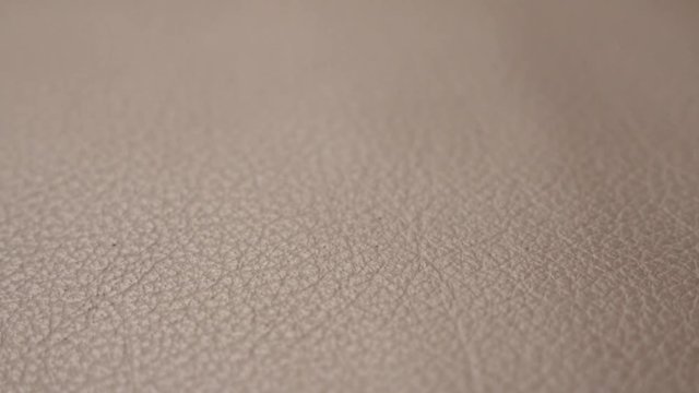 Animal origin leather sofa detailed surface close-up 3840X2160 UHD tilting footage - Slow pan on brown contemporary sofa fine texture 4K 2160p UHD video 