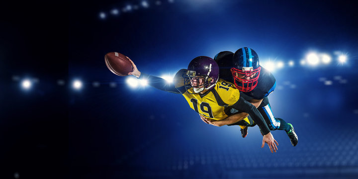 American football players at arena . Mixed media © Sergey Nivens