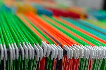 Abstract background colorful hanging file folders in drawer.