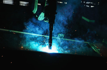 Robots used Metal Welding with sparks and smoke in  heavy industry