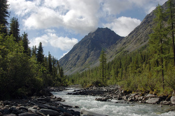 Fototapeta na wymiar Mountain river surrounded by high peaks.