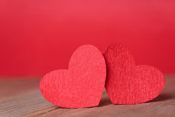 Obraz premium Valentines day concept of two red heart shape cards with red background.