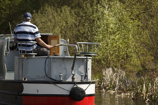 Aged Men On Narrow Boat In Canal, England