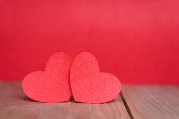Valentines day concept of two red heart shape cards with red background.