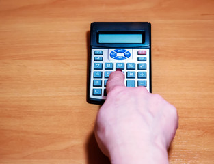 Paying bills, woman hand press Calculator