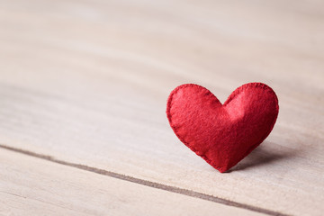 Fototapeta premium Valentines day concept of one heart shape decoration with old wood floor background.