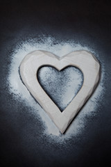 Holidays gift and heart on a black background. Valentines day