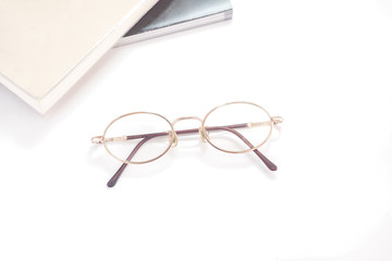 Eye glasses isolated with books