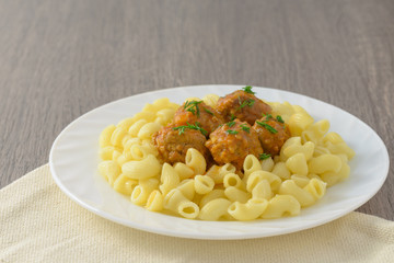 Pasta with meatballs on the plate.