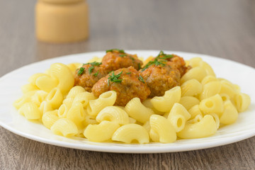 Pasta with meatballs on the plate.