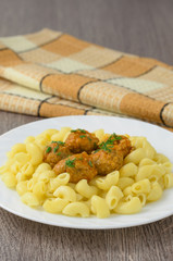 Pasta with meatballs on the plate.
