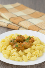 Pasta with meatballs on the plate.