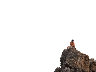 Photographer taking photo on top of the rock mountain at the sea