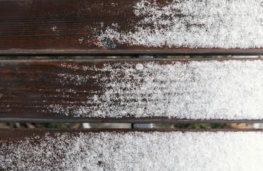 Wooden bench with snow