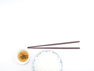 Rice in a bowl with chopsticks isolated top view (copy space)