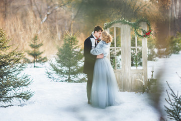 Bride and groom embracing. Outdoors wedding.