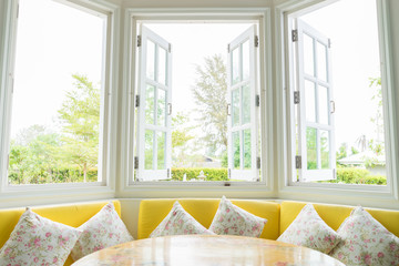 White window with yellow sofa