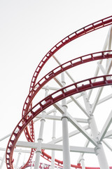 Roller coaster (red) in the amusement park isolated