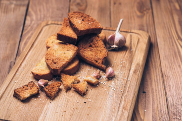 Bread crumbs, spices, garlic on wooden background.