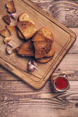 Bread crumbs, spices, garlic on wooden background.