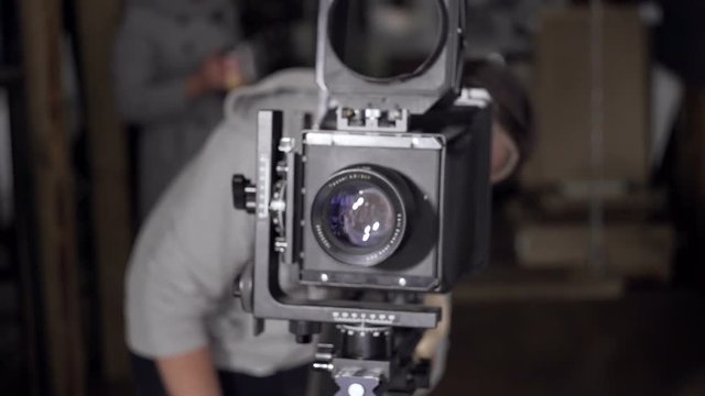 Men prepare the retro camera to shoot close-up