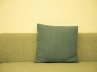 green pillow on green fabric sofa
