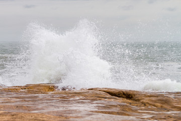 A sea wave breaks against the rocks on the shores of Mar del Pla