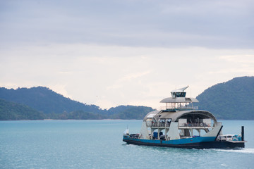 Yacht in the ocean with island background