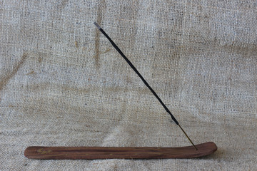 Incense stick on a wooden support
