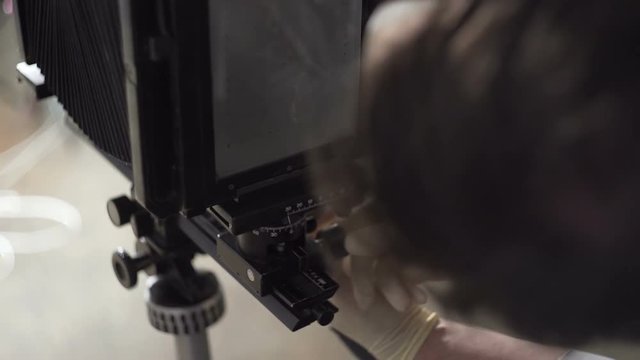 Men prepare the retro camera to shoot close-up