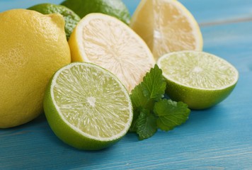 limes and lemons on a wooden background