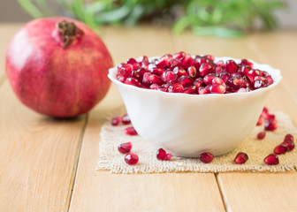 Still life with fresh pomegranate on a wooden table.